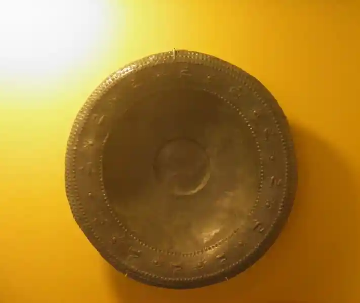 Dish with suns and animals alternating design on the rim